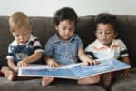 three toddlers reading story time children