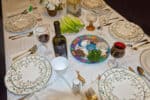 Passover (Pesach) table setting with Jewish sedar plate.