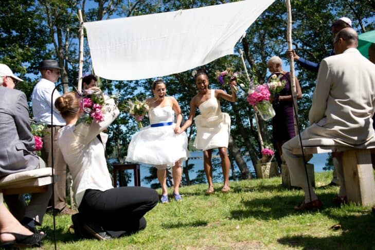 Rachel Spekman and Robin Smith jump over the broom at their 2013 wedding (Photo: Evgenia Eliseeva/Eve Photography)