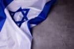 Holocaust Remembrance Day. Yom HaShoah. Official flag of Israel on a dark grey background. Memorial Day for Jewish people.