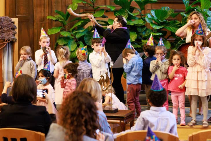 Rosh Hashanah Young Family service with children wearing birthday hats to celebrate the birthday of the world