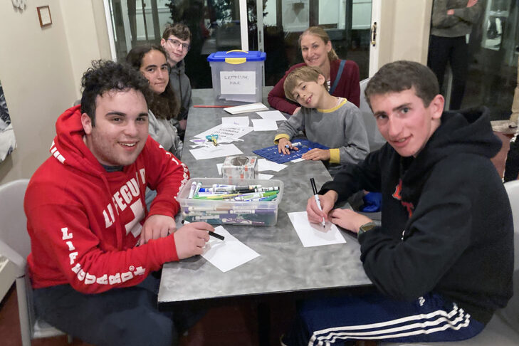Teens from Israel and MetroWest make signs and decorations for Pop-Up Israel at Congregation Beth El (Courtesy photo)