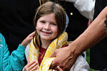 Rashi Reptiles 2025 A little girl with a yellow snake around her neck, in a relaxed way