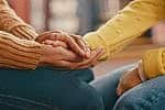 Hands, love and care touching in support, trust or unity for community, compassion or understanding. People holding hands in respect for loss, affection or passion for listening, talk or time Hands, love and care touching in support, trust or unity for community, compassion or understanding. People holding hands in respect for loss, affection or passion for listening, talk or time