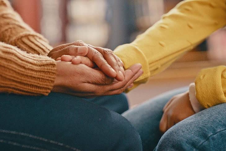 Hands, love and care touching in support, trust or unity for community, compassion or understanding. People holding hands in respect for loss, affection or passion for listening, talk or time Hands, love and care touching in support, trust or unity for community, compassion or understanding. People holding hands in respect for loss, affection or passion for listening, talk or time