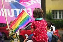 LGBTQIA Queer Pride Little kid sit mother shoulder. Gay protest against no homophobia. Family walk lgbt pride parade. Child watch lesbian strike. Bi parent show us csd fest daughter. Peaceful rally Girl hold rainbow flag