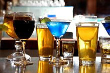 Beer Wine Cocktails Drinks Alcohol Happy Hour An assortment of various alcoholic drinks back lit on a bar.