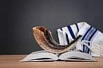 Yom Kippur Shofar image of shofar (horn) on white prayer talit. Rosh hashanah (jewish New Year holiday), Shabbat and Yom kippur concept